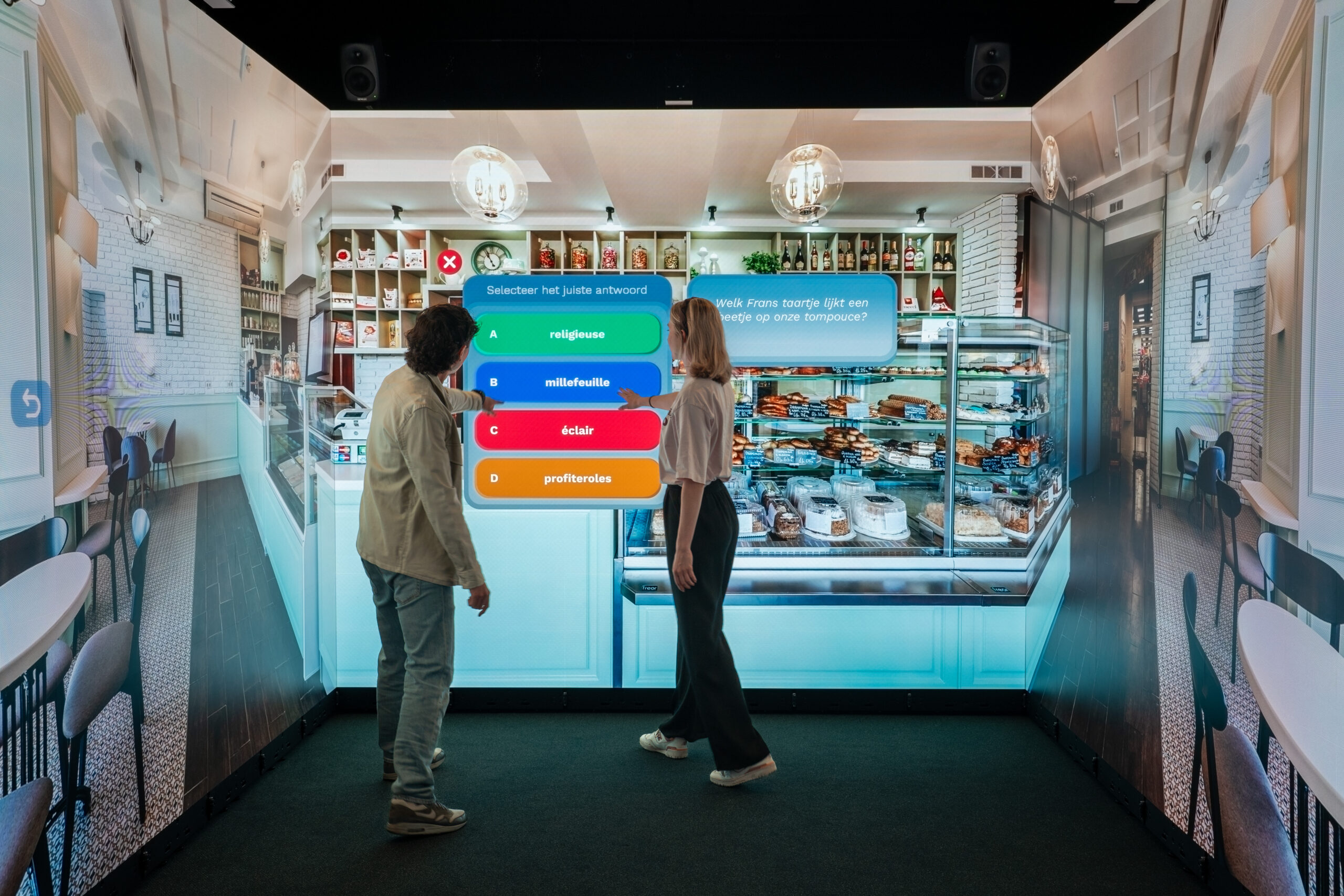 People completing an interactive learning quiz in a virtual bakery inside an Immersive Room