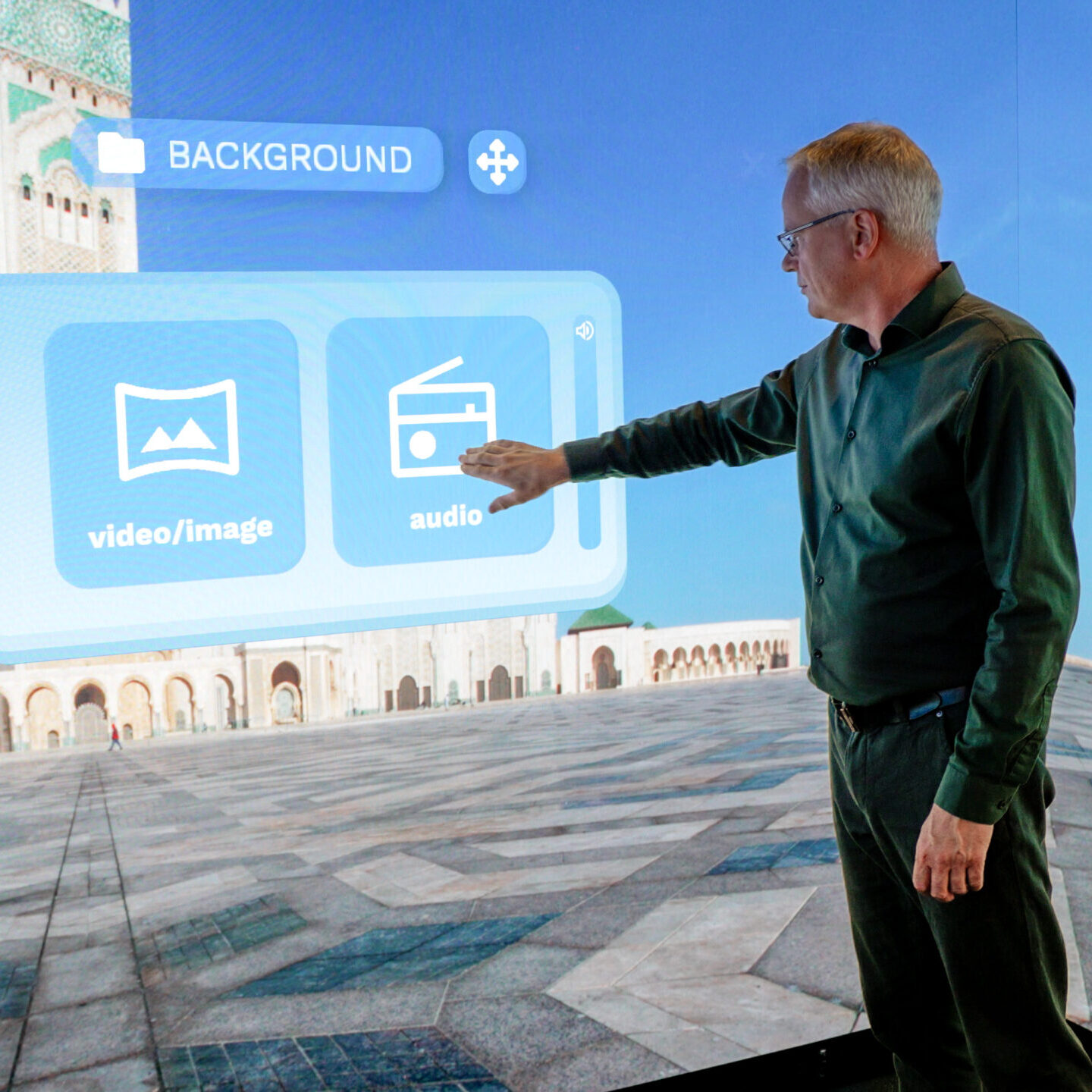 User interacting with multimedia controls in the Immersive Suite software inside an Immersive Room