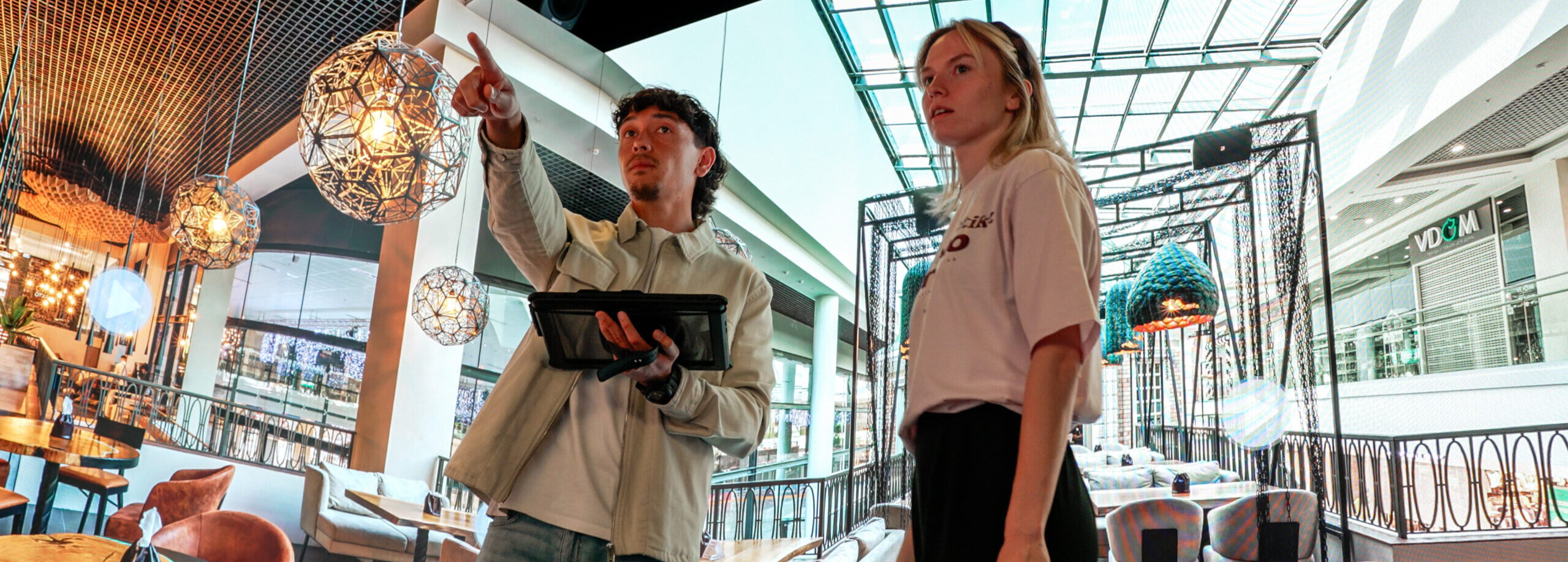 People exploring an immersive restaurant environment using interactive technology in an Immersive Room
